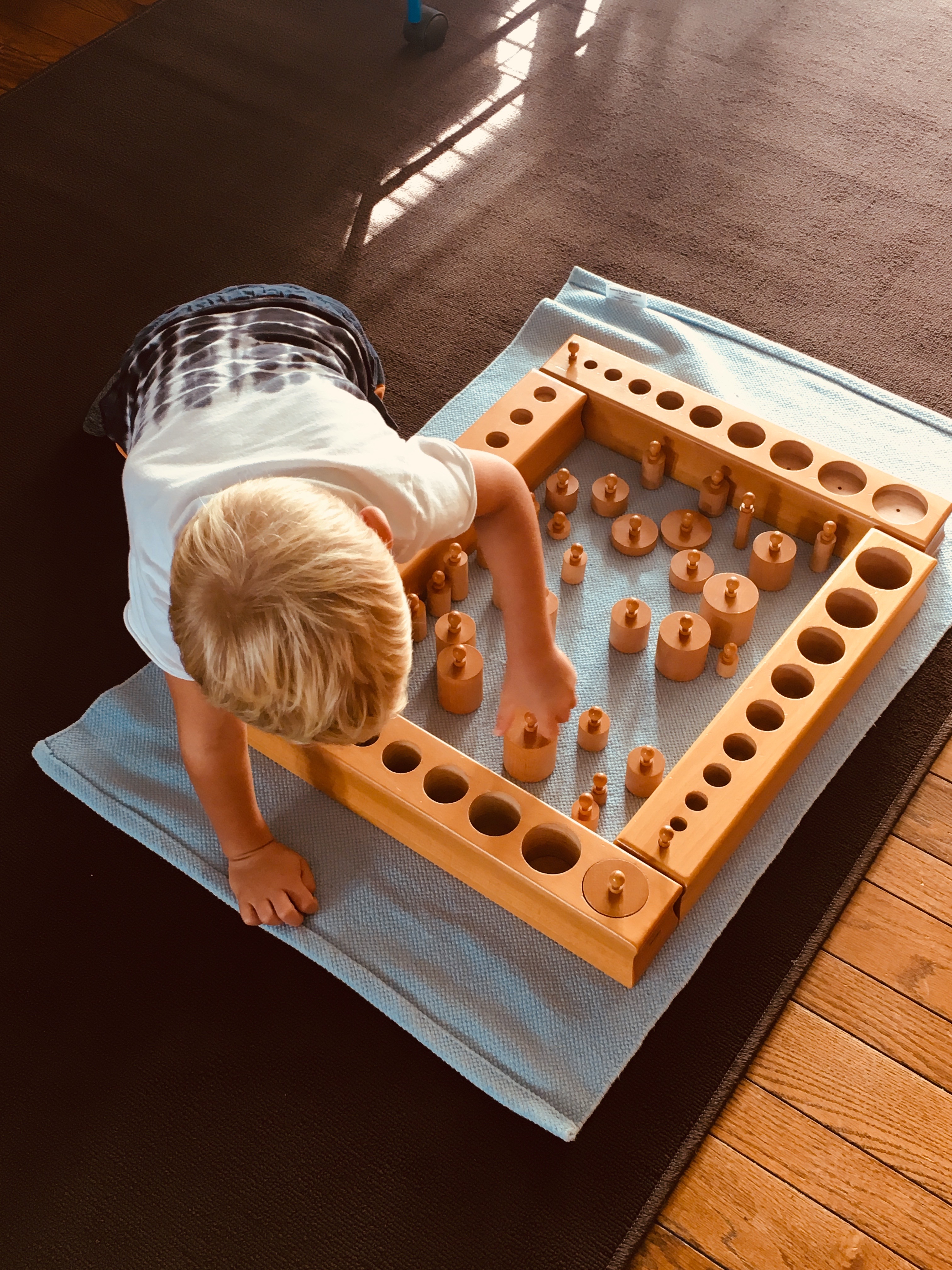 Samuel, age 4, working with all four sets of knobbed cylinders.