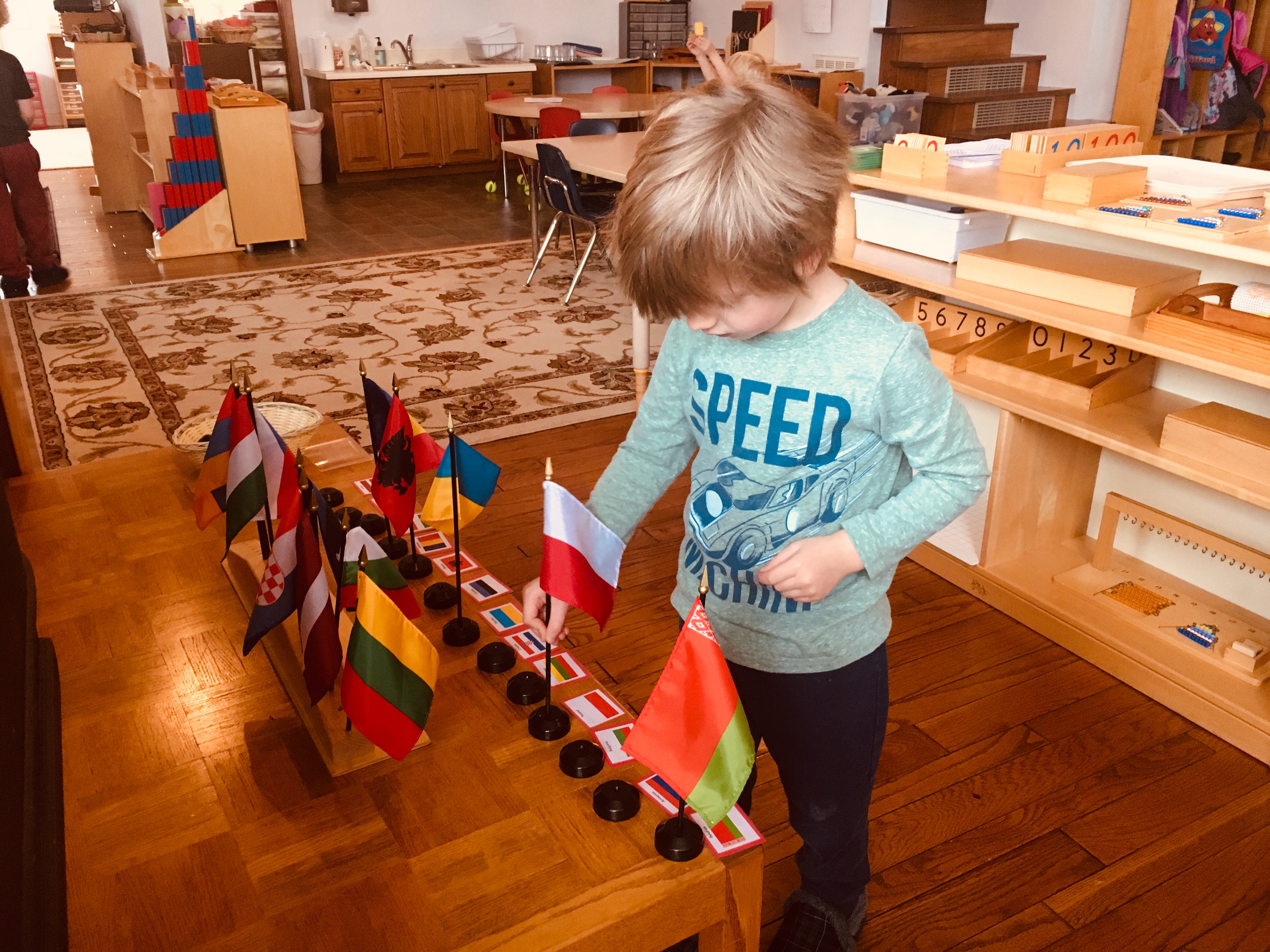 Wesley, age 4, matches flags with images of the flags on cards.
